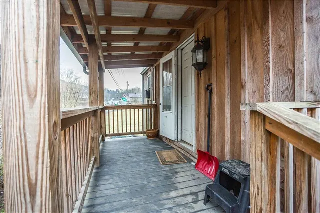 a view of porch with wooden floor