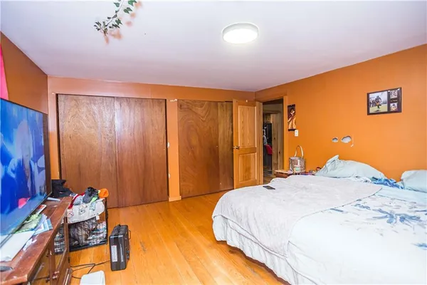 a spacious bedroom with a bed and a chandelier