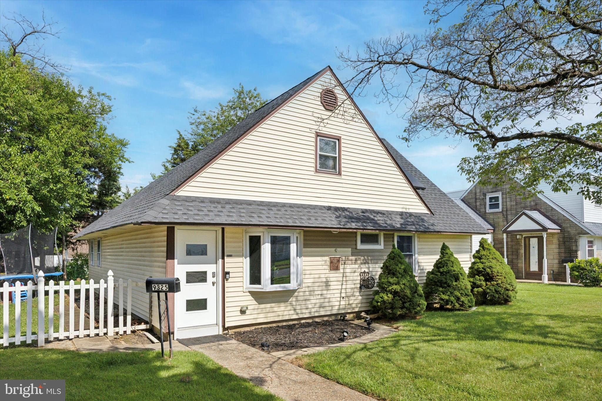 a view of a house with a yard and a garden