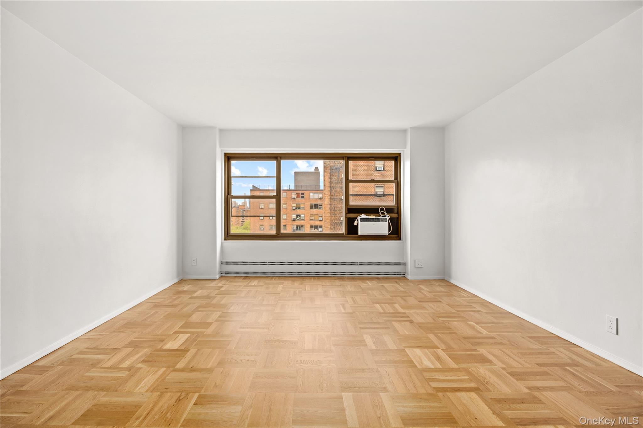 21-66 33rd Road, Unit 12B Queens, NY 11106 - Photo 4 of 23 an empty room with windows