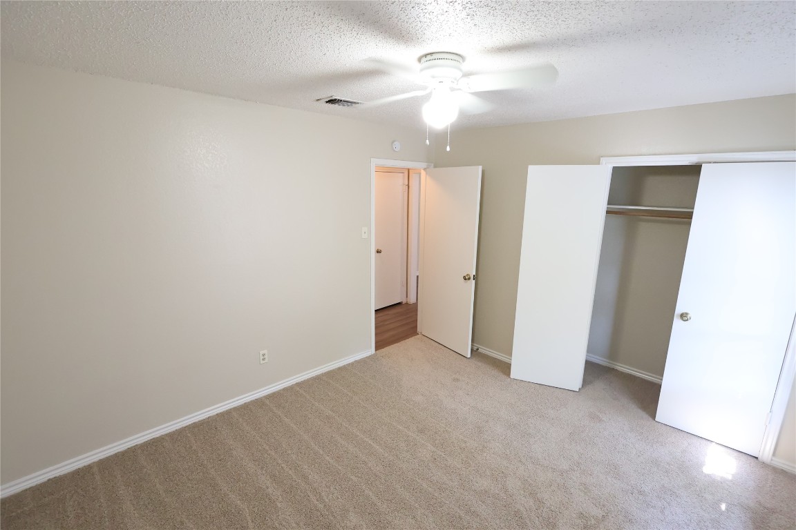 6714 Windrift Way Austin, TX 78745 - Photo 11 of 20 an empty room with closet and a ceiling fan