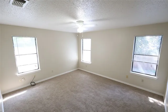 an empty room with windows and closet