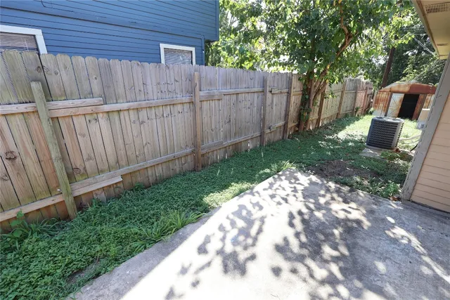 a view of a backyard with wooden fence