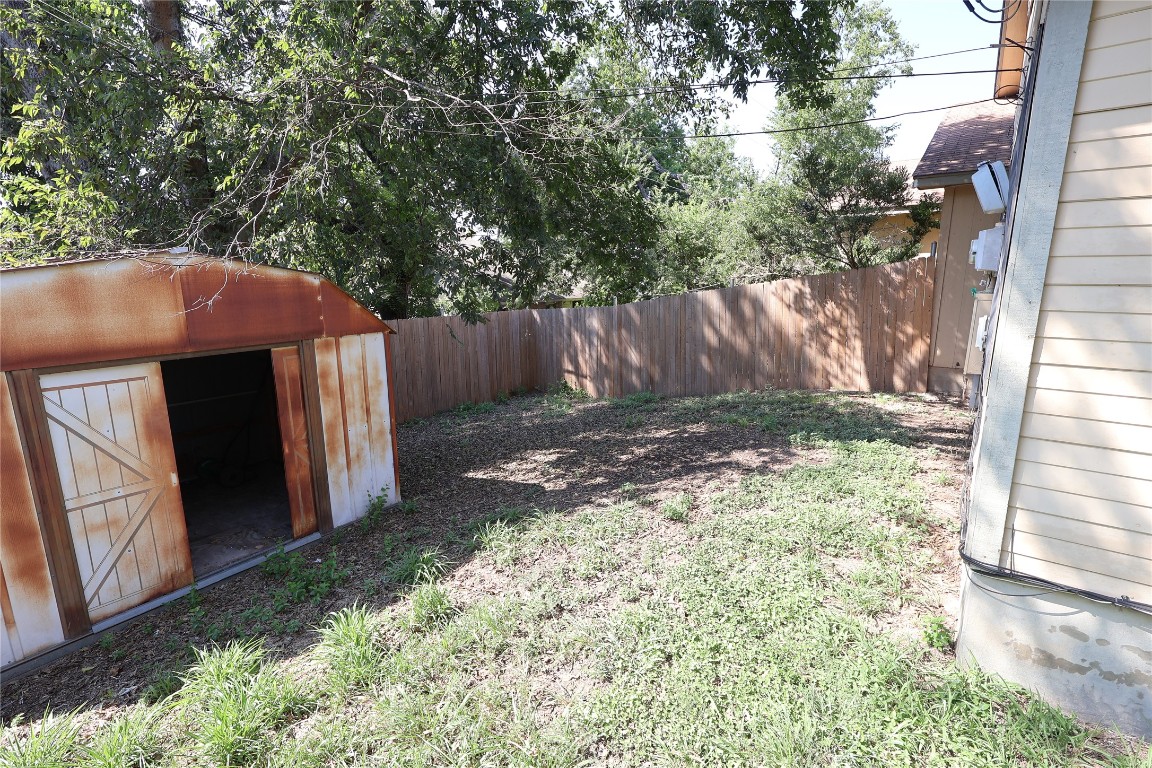 6714 Windrift Way Austin, TX 78745 - Photo 19 of 20 a view of a backyard with a tree and wooden fence