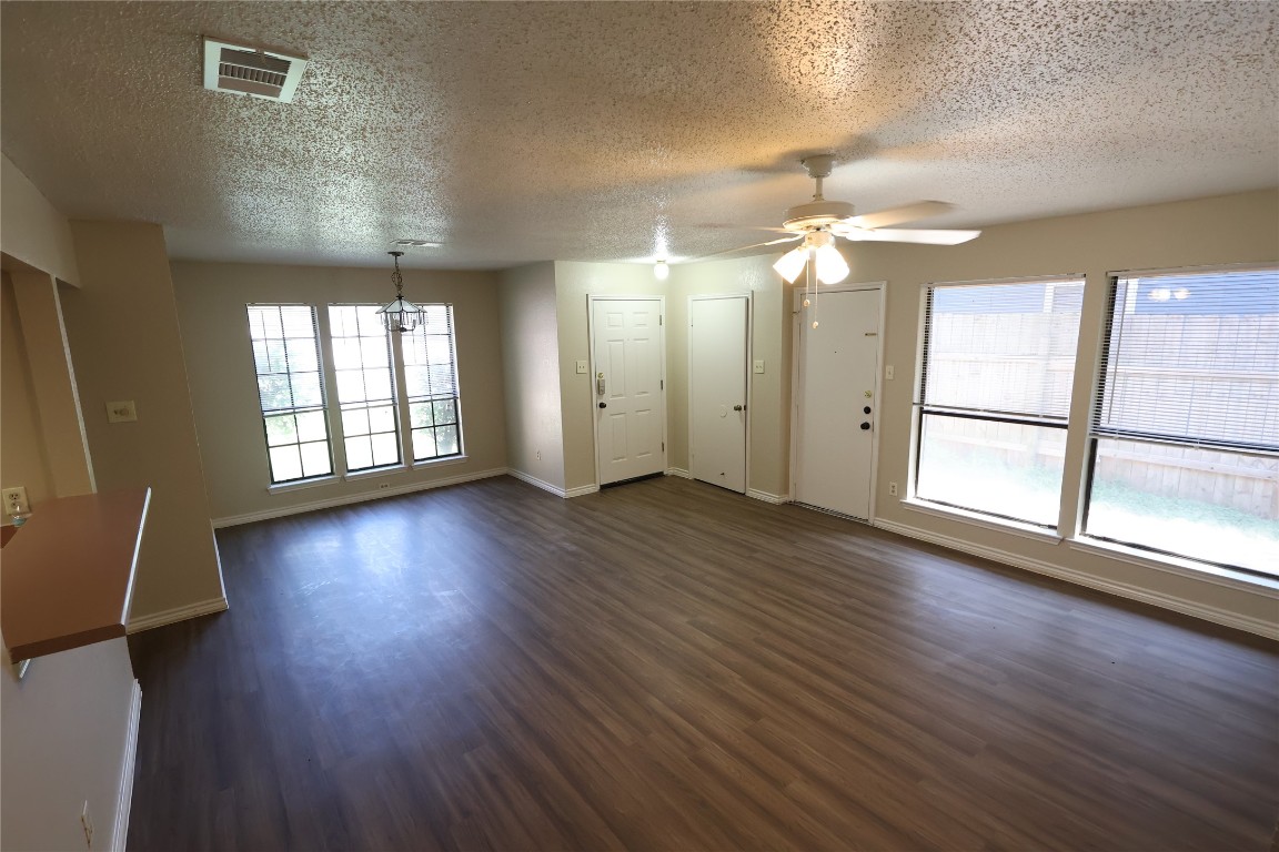 6714 Windrift Way Austin, TX 78745 - Photo 9 of 20 a view of an empty room with wooden floor and a window