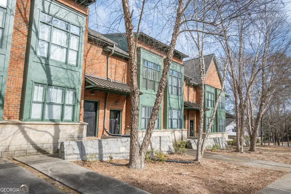 a view of a brick building next to a road