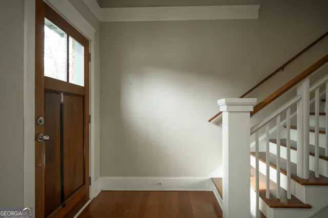 a view of a room with wooden floor and window