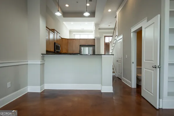 a view of a kitchen with a refrigerator and microwave