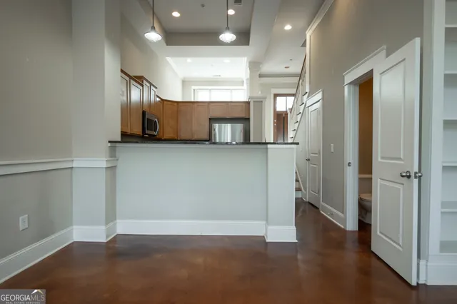 a kitchen with stainless steel appliances a refrigerator stove and microwave