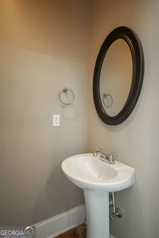 a view of an empty room with wooden floor and windows