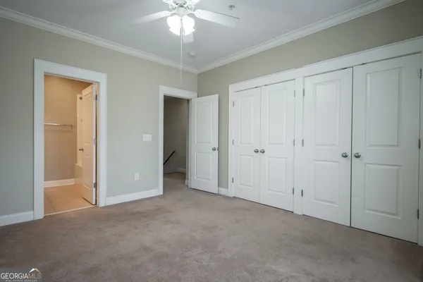 a view of an empty room and a bathroom