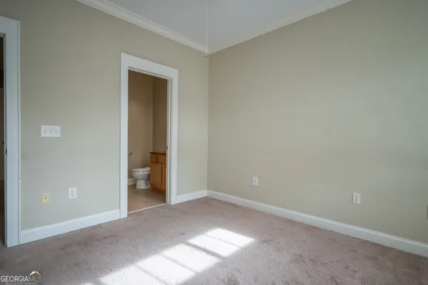 a view of an empty room and closet area