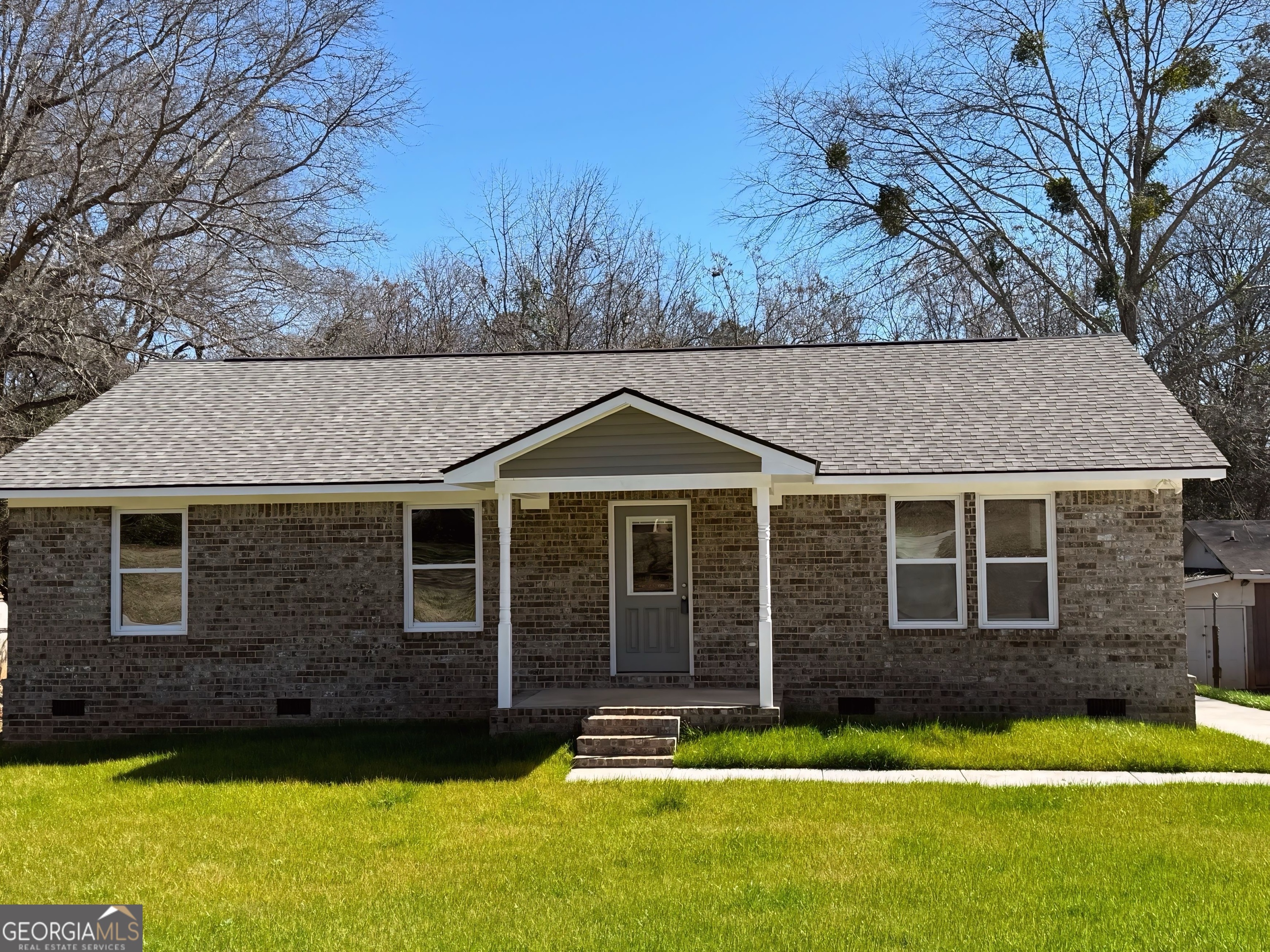 24 George Street Forsyth, GA 31029 - Photo 1 of 20 a front view of a house with a yard
