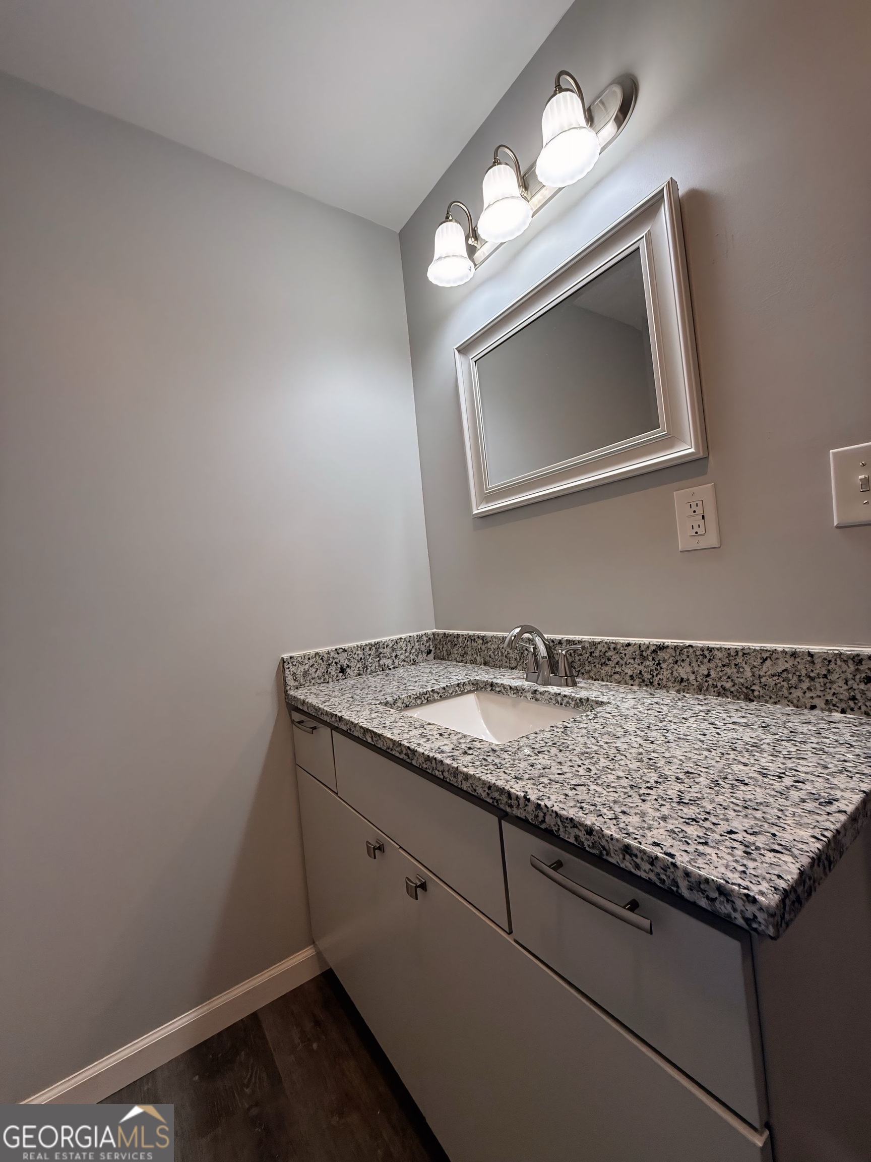 24 George Street Forsyth, GA 31029 - Photo 15 of 20 a bathroom with a granite countertop sink and a mirror