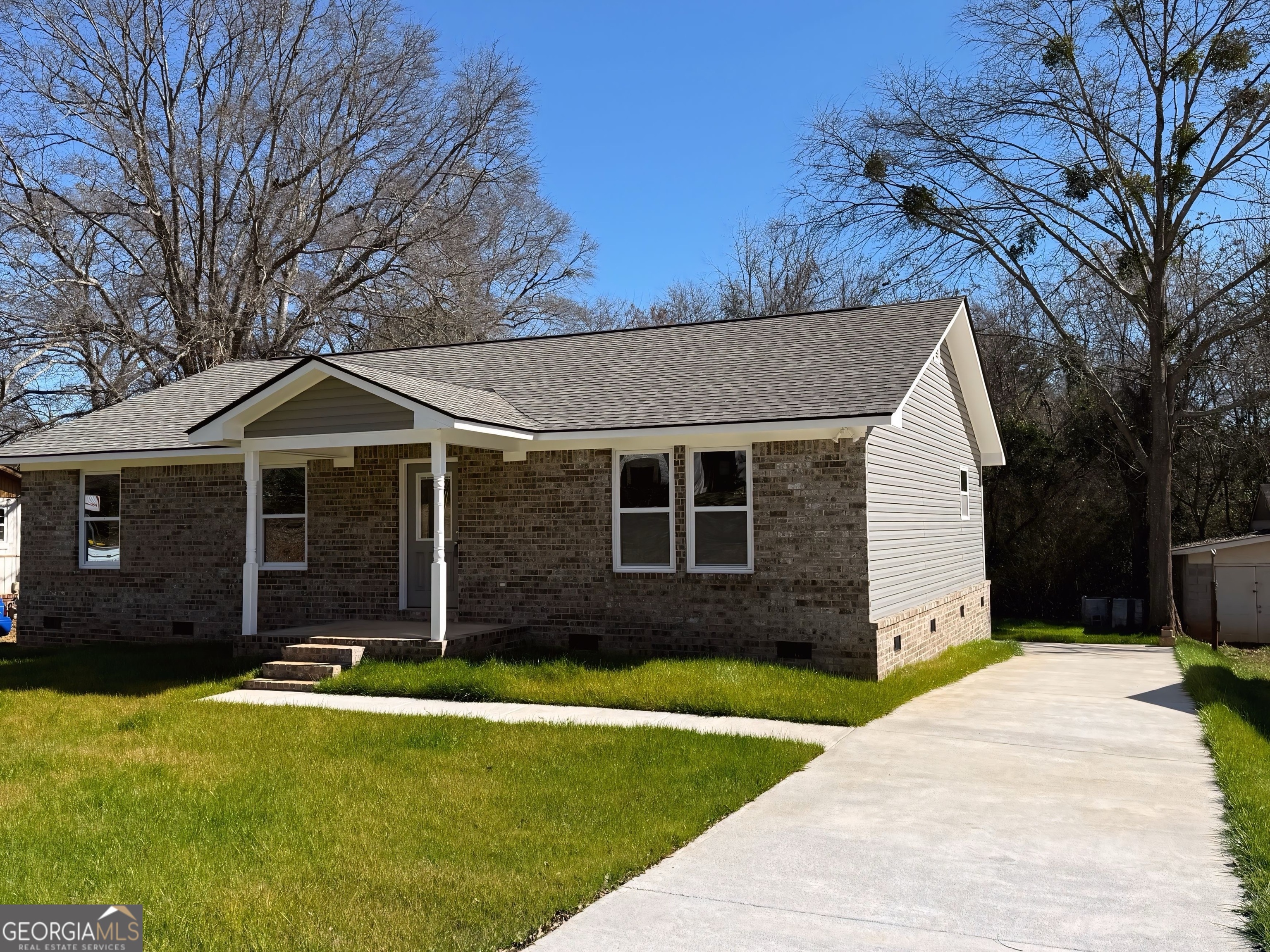 24 George Street Forsyth, GA 31029 - Photo 2 of 20 a front view of a house with a yard and garage