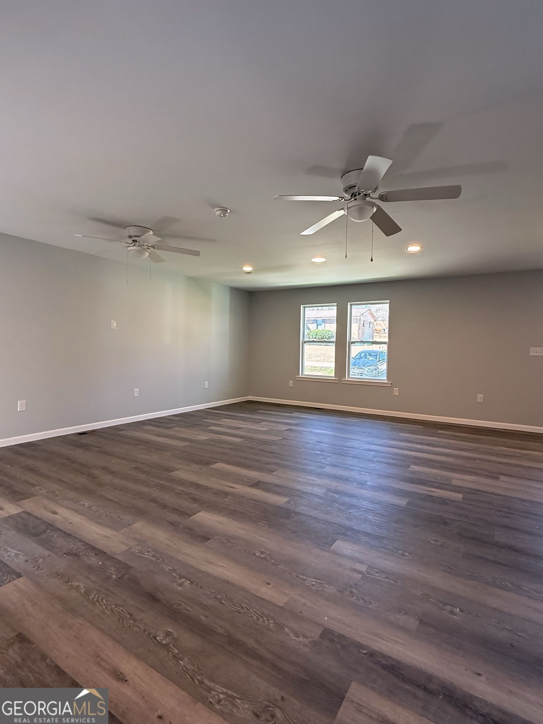 24 George Street Forsyth, GA 31029 - Photo 3 of 20 wooden floor in an empty room with a window