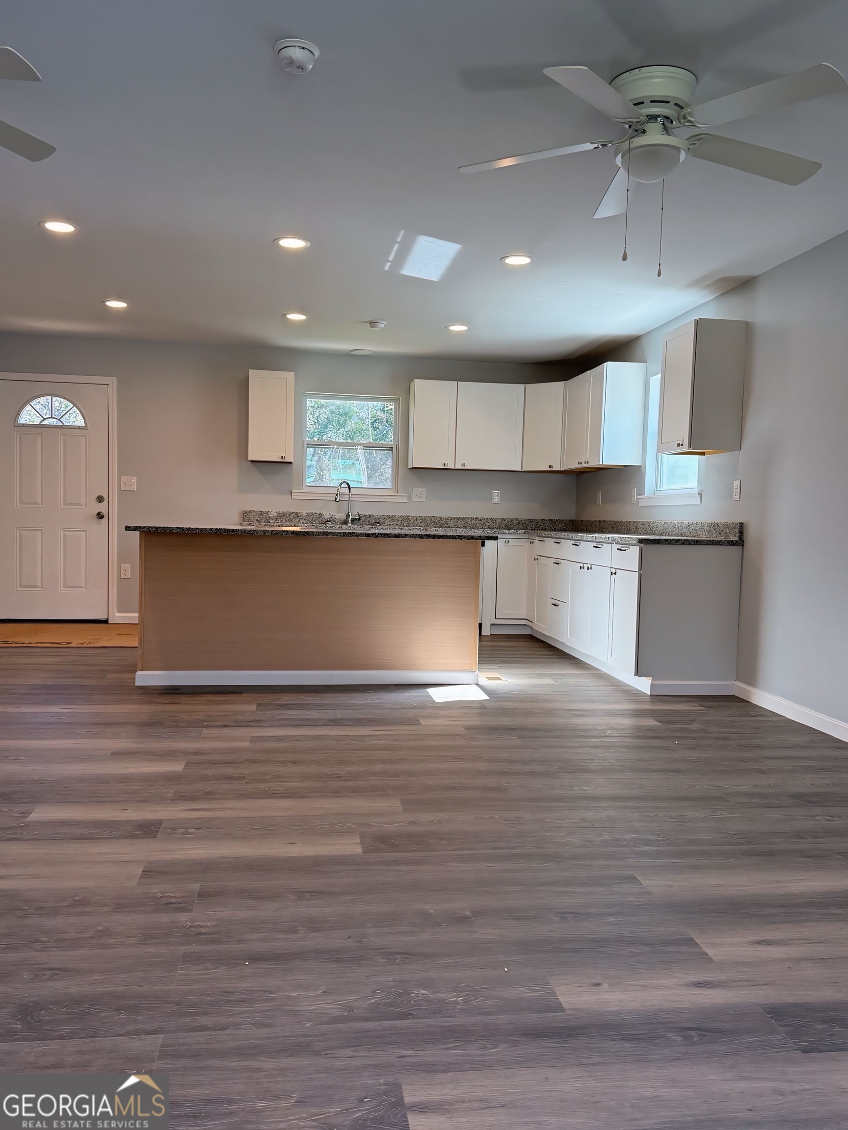 24 George Street Forsyth, GA 31029 - Photo 6 of 20 a view of kitchen with cabinets and wooden floor