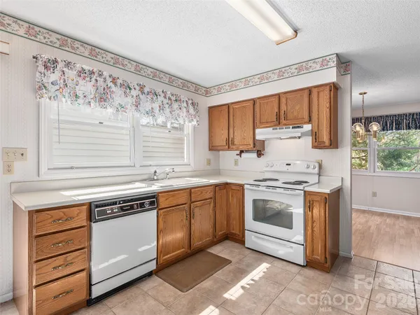 a kitchen with stainless steel appliances granite countertop a stove and a sink
