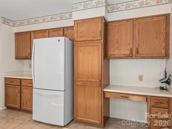 a white refrigerator freezer sitting in a kitchen
