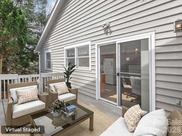 a balcony with furniture and a potted plant