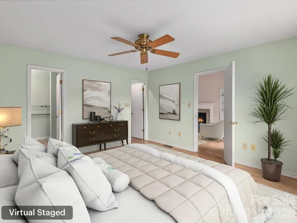 a bedroom with a large bed and a chandelier