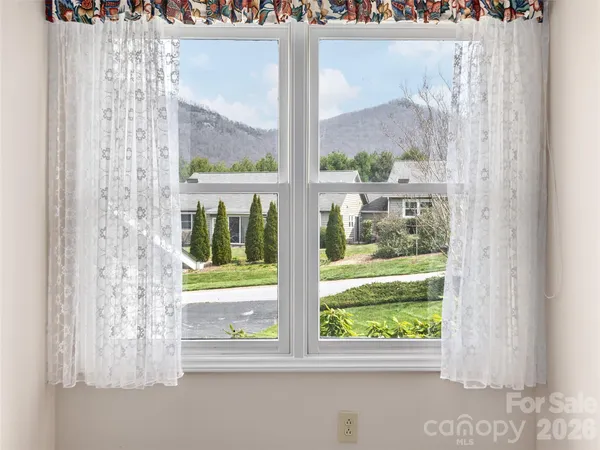 a view of a glass door with a yard