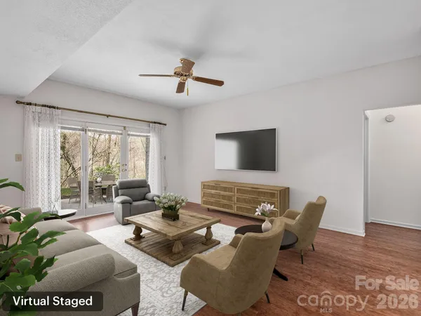 a living room with furniture and a floor to ceiling window