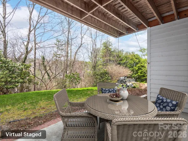 a view of a porch with furniture and a yard