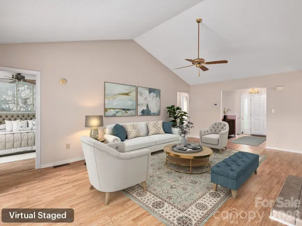 a living room with furniture a rug and a chandelier