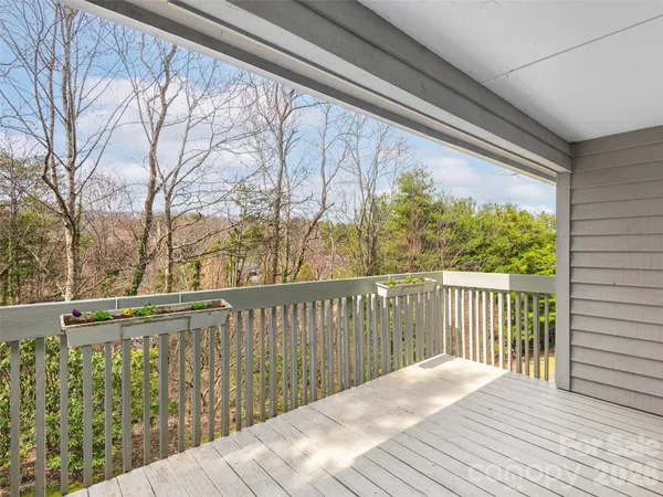 a view of balcony with wooden floor