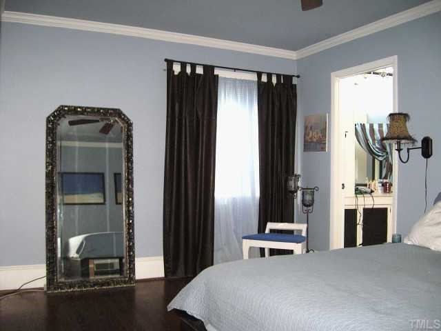 823 Graham Street Raleigh, NC 27605 - Photo 8 of 12 a bedroom with a bed and a mirror