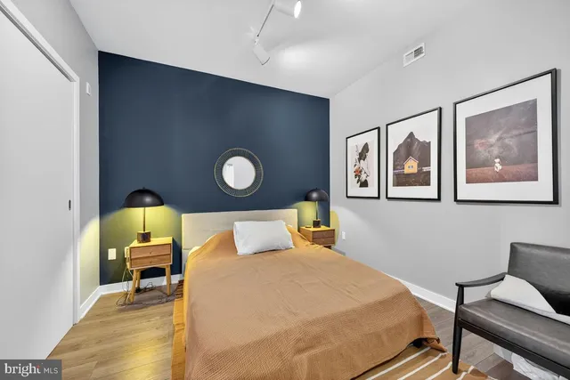 a bedroom with a bed and wooden floor