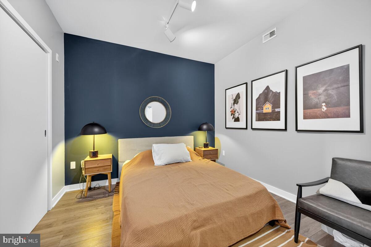 2030 8th Street Northwest, Unit 507 Washington, DC 20001 - Photo 11 of 23 a bedroom with a bed and wooden floor