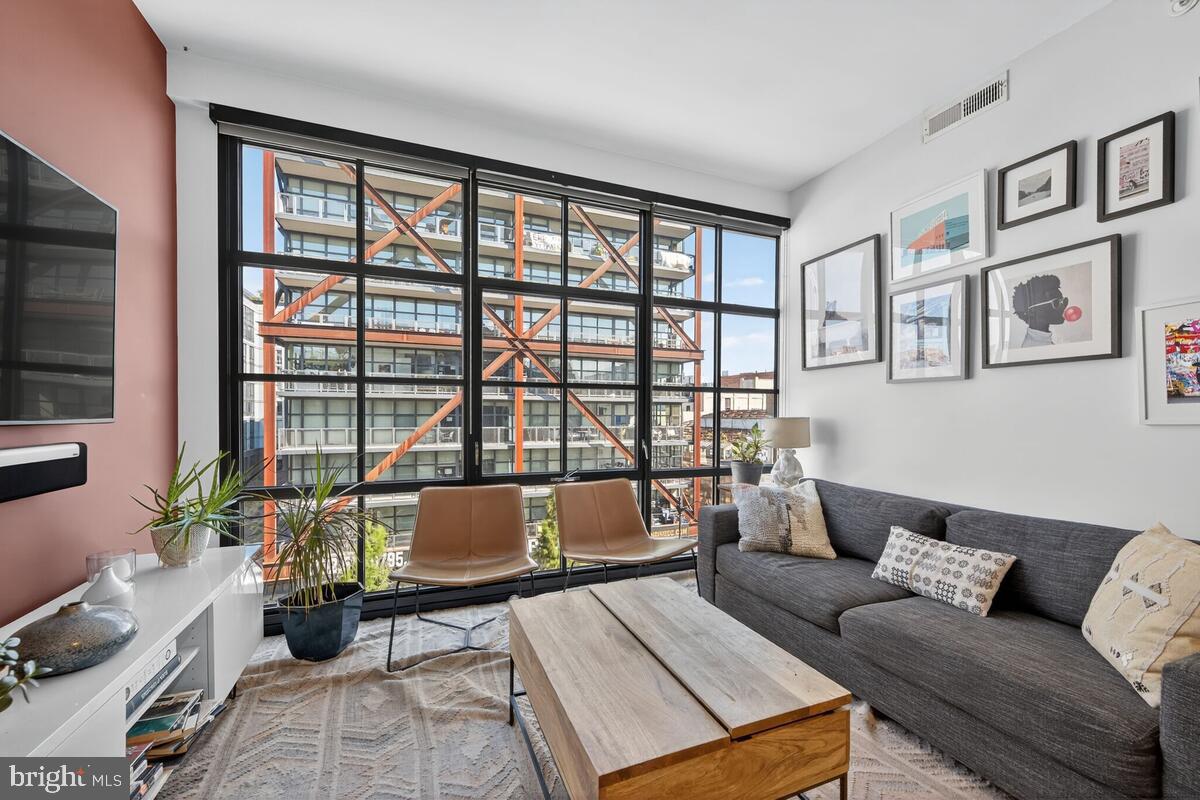 2030 8th Street Northwest, Unit 507 Washington, DC 20001 - Photo 6 of 23 a living room with furniture and floor to ceiling windows