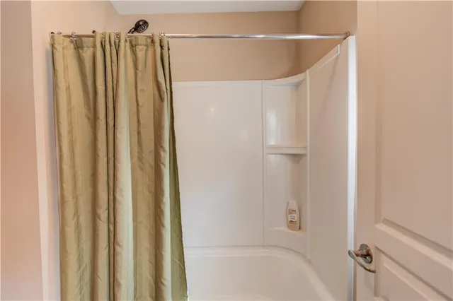 a view of a big room with a small yard and large trees