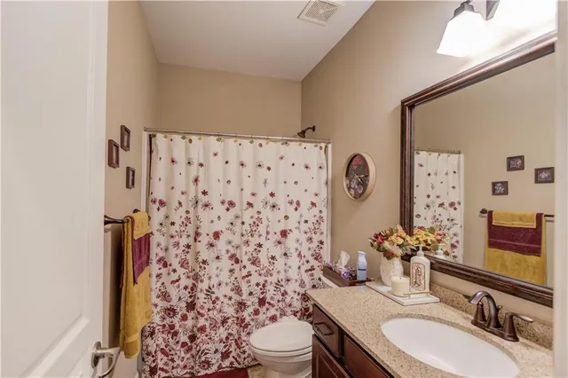 a kitchen with a sink stove and chairs