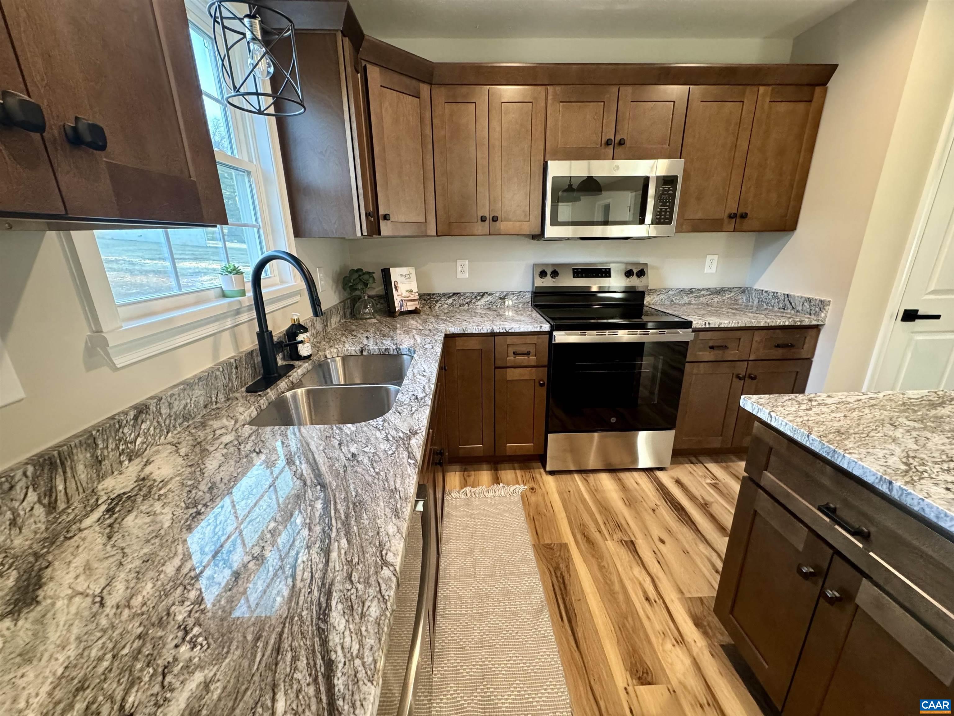 200 Robinhood Road Staunton, VA 24401 - Photo 12 of 75 a kitchen with granite countertop a stove a sink and a microwave