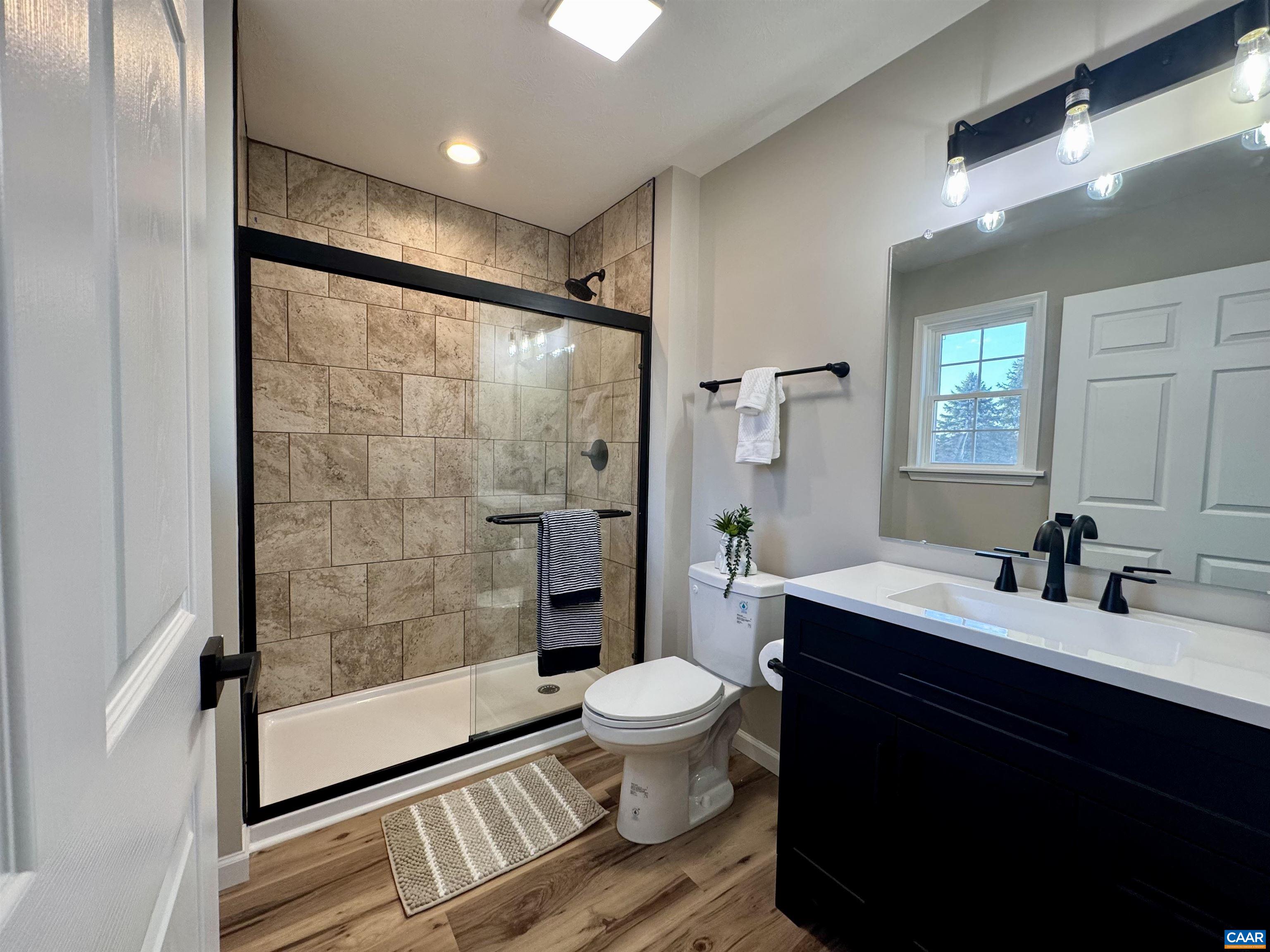 200 Robinhood Road Staunton, VA 24401 - Photo 18 of 75 a bathroom with a sink a toilet a mirror and a glass door shower