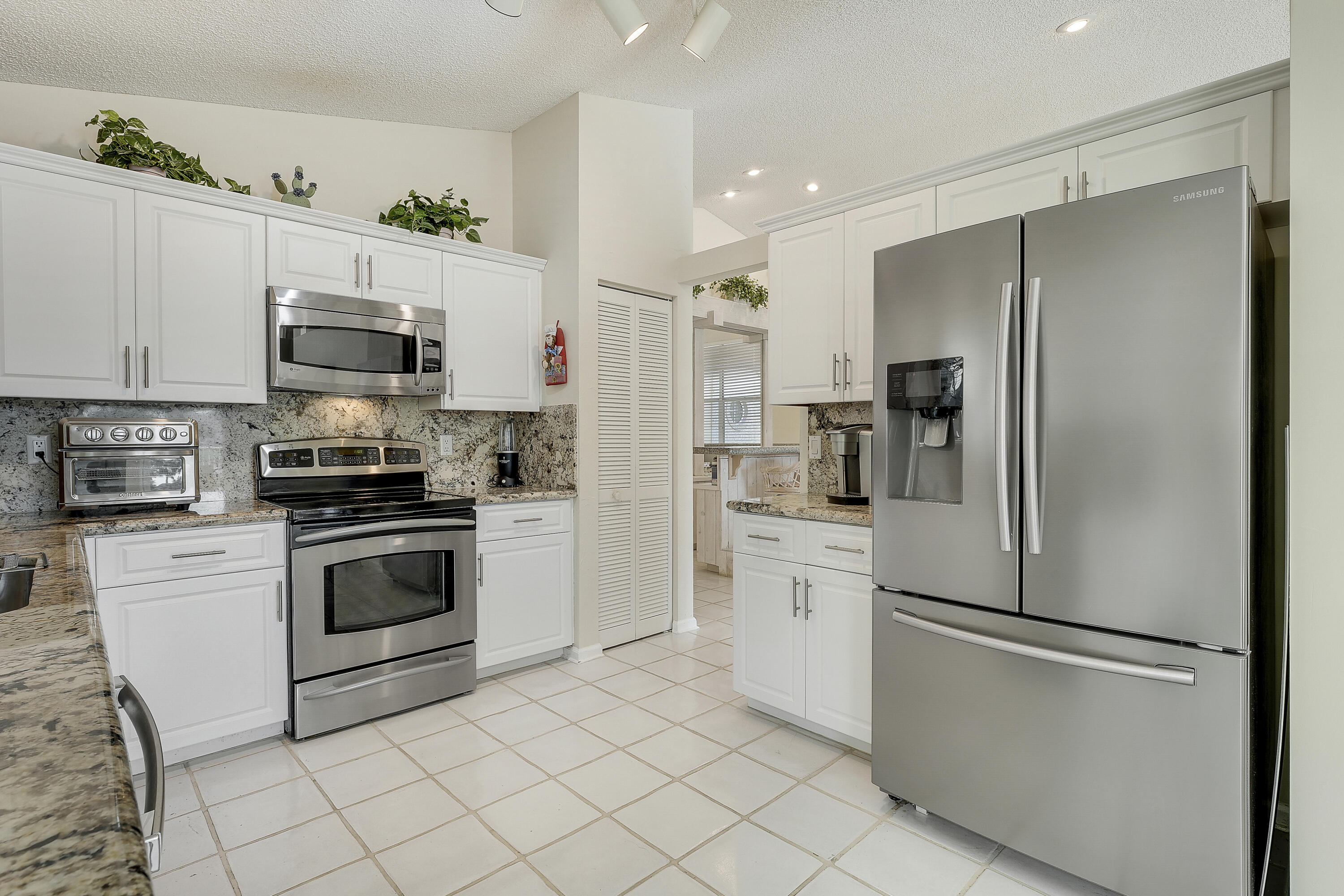 7283 Via Palomar Boca Raton, FL 33433 - Photo 18 of 43 a kitchen with cabinets stainless steel appliances and a counter space