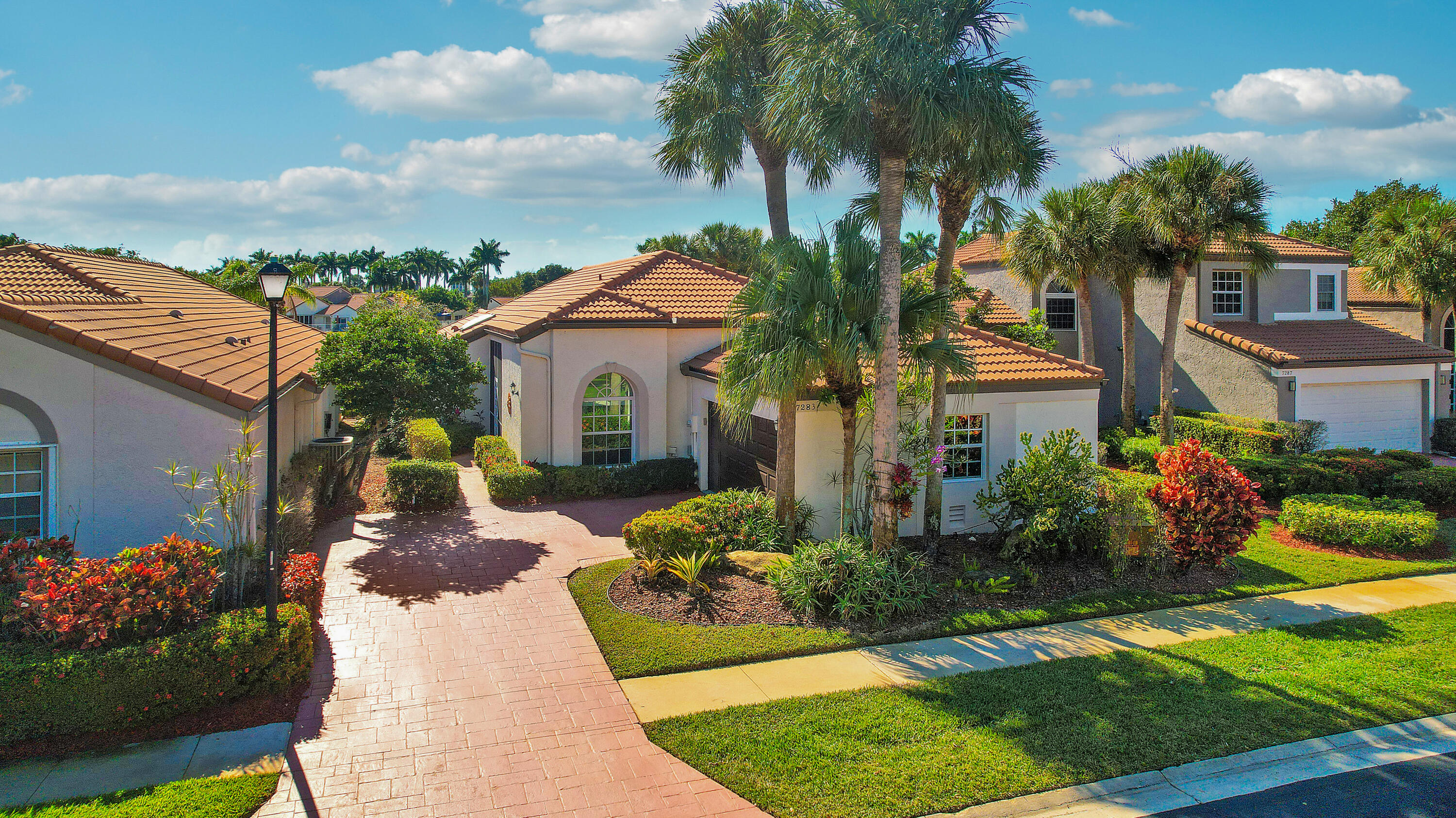 7283 Via Palomar Boca Raton, FL 33433 - Photo 2 of 43 a view of a house with a yard and potted plants