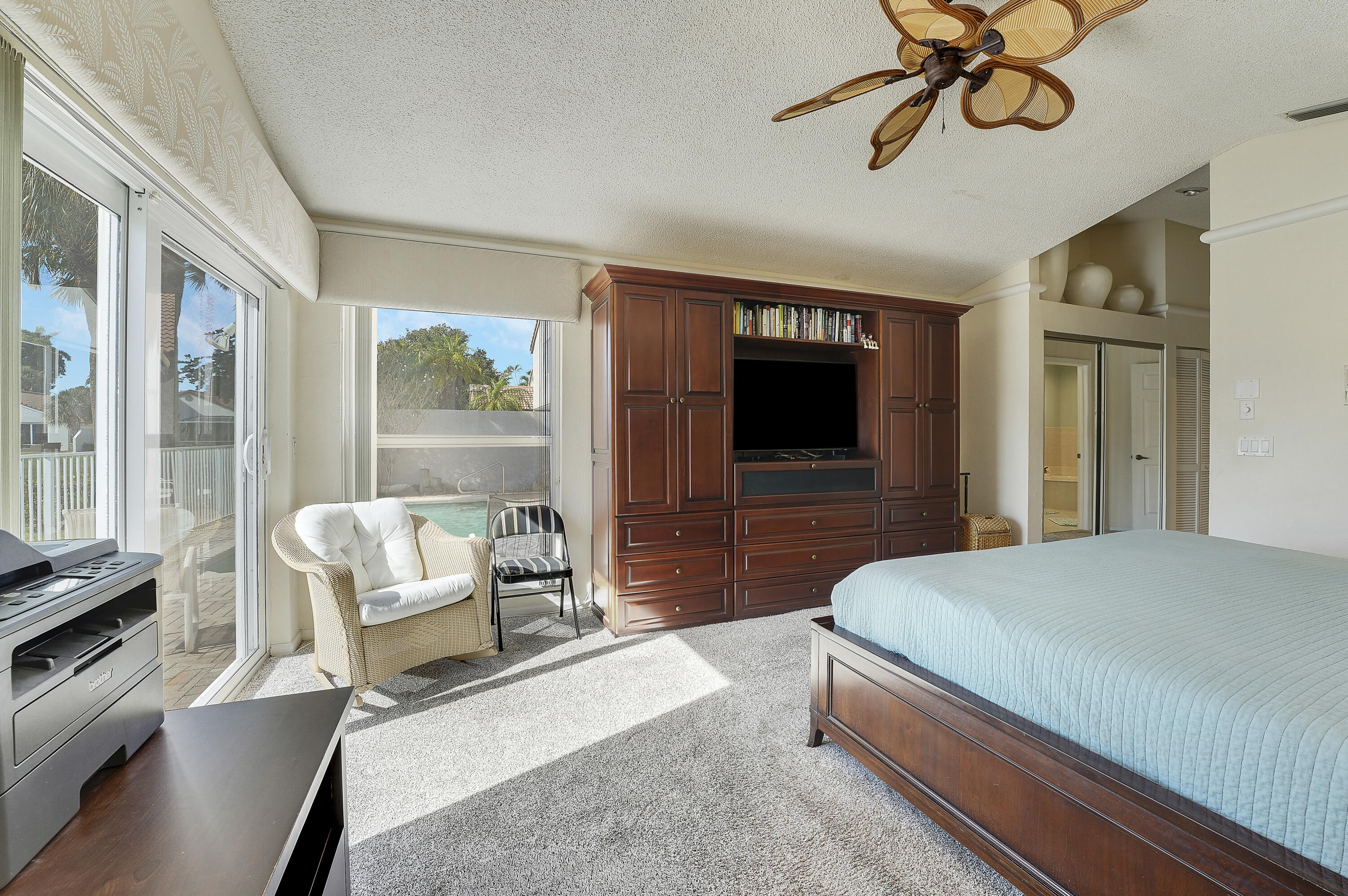 7283 Via Palomar Boca Raton, FL 33433 - Photo 24 of 43 a bedroom with a bed and a chandelier