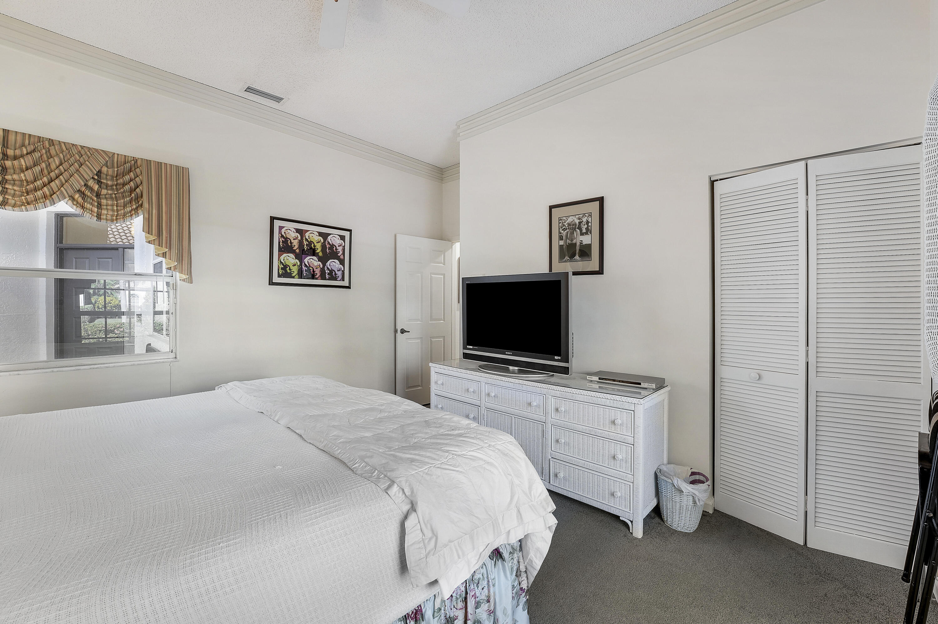 7283 Via Palomar Boca Raton, FL 33433 - Photo 29 of 43 a bedroom with a bed and a flat screen tv