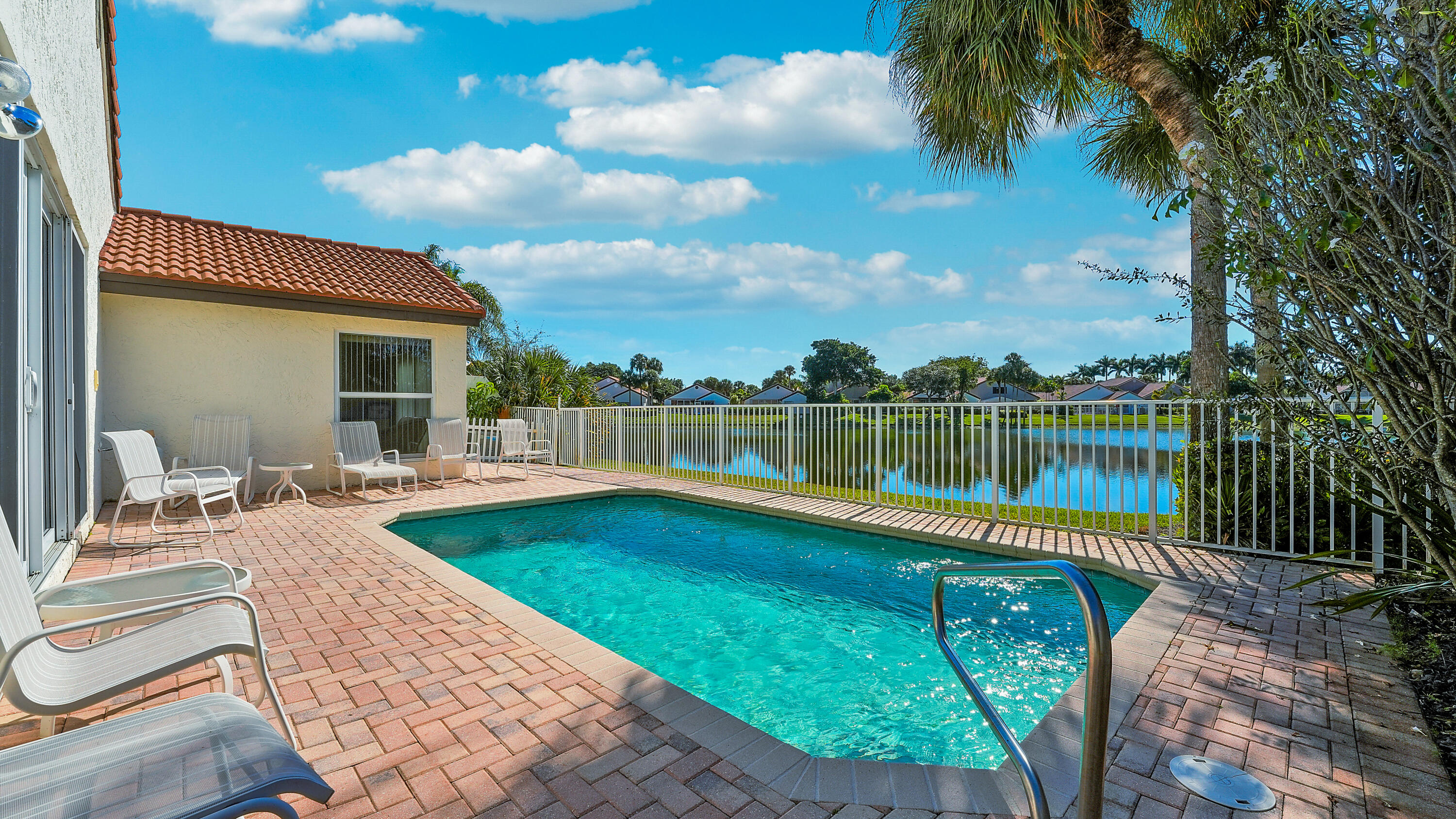 7283 Via Palomar Boca Raton, FL 33433 - Photo 34 of 43 a view of a swimming pool with a patio and a yard