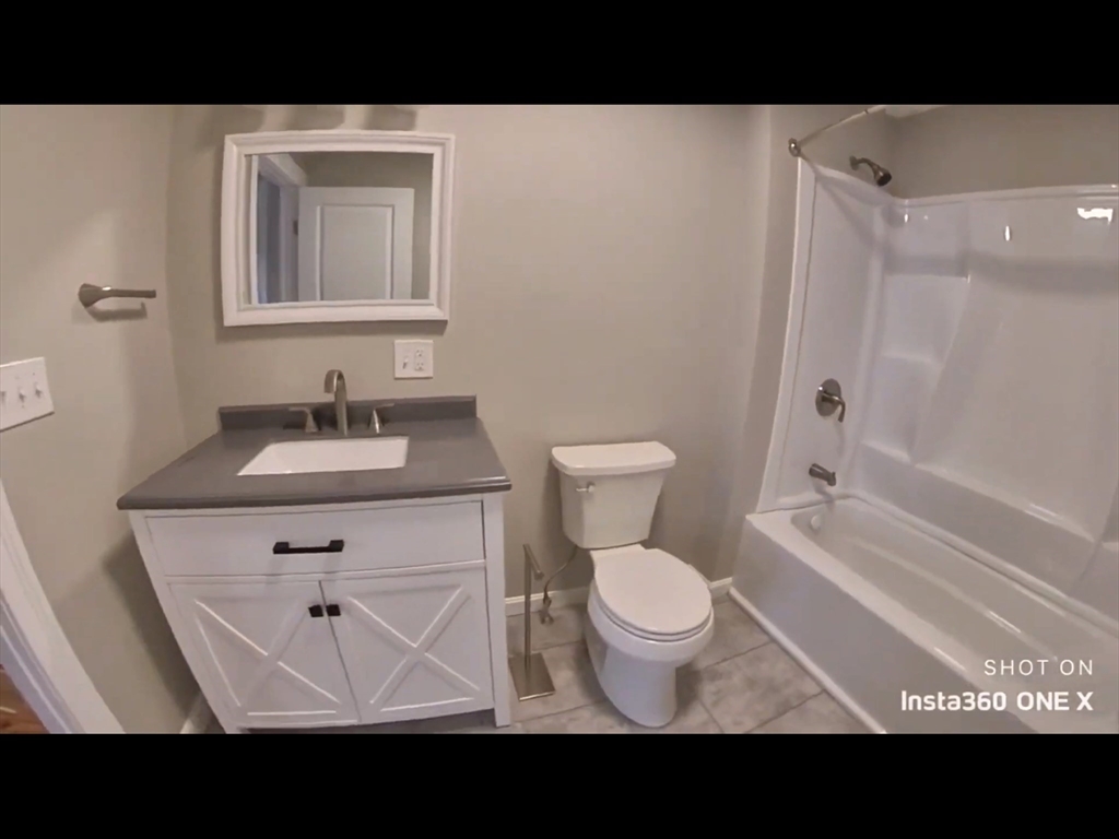 101-103 Lexington Street Newton, MA 02466 - Photo 12 of 37 a bathroom with a sink toilet a vanity and shower