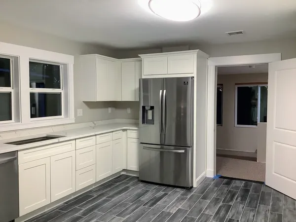 a kitchen with a refrigerator and cabinets