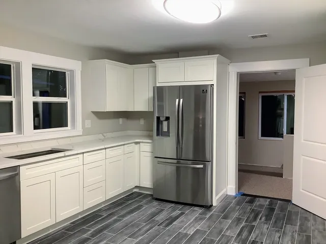 a kitchen with a refrigerator and cabinets