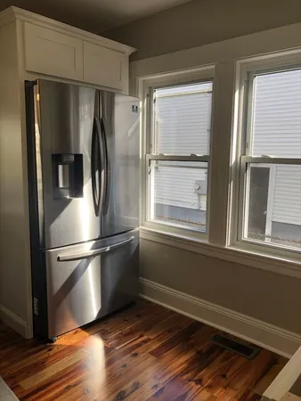 a metallic refrigerator freezer sitting in a kitchen