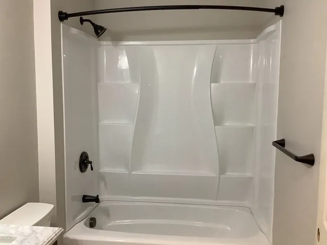a bathroom with a shower and a bath tub