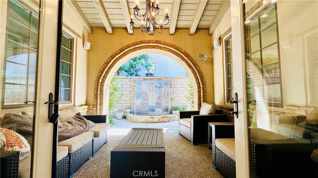 24 Silhouette Irvine, CA 92603 - Photo 11 of 36 a living room with fireplace furniture and a large window