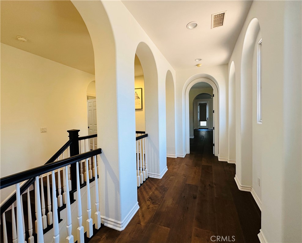 24 Silhouette Irvine, CA 92603 - Photo 14 of 36 a view of a hallway with wooden floor and staircase